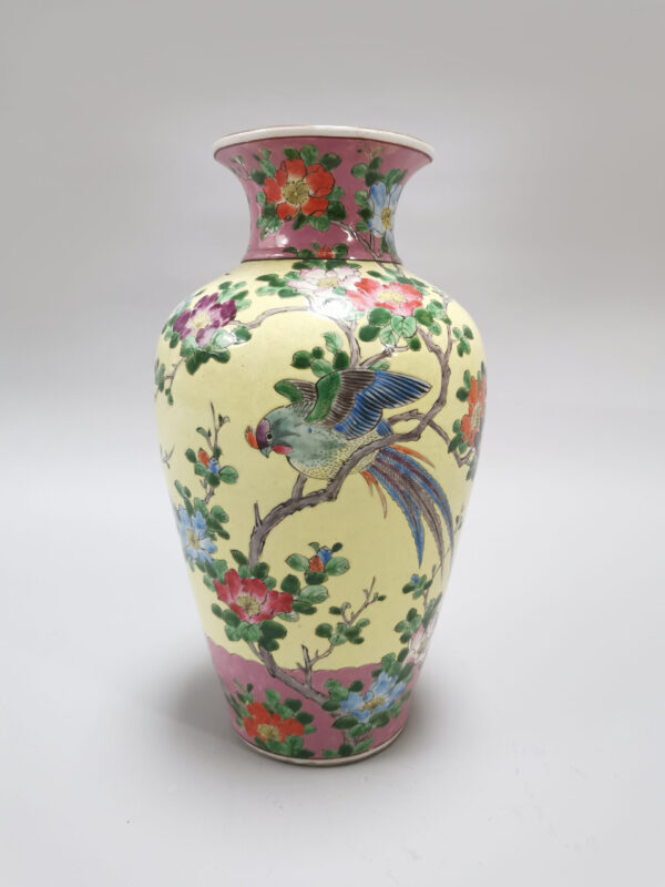 A Japanese porcelain vase with a rich colorful enamel exotic bird and flower scene, iron red marked, Early 20th century