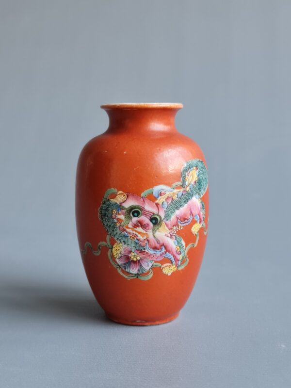 A Chinese red coral  glazed vase depicting the image of a qilin,  markerd Qianlong